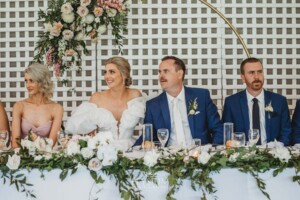 Newlyweds listen to the speeches during the wedding reception