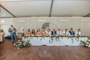 The brides father stands at the end of the bridal table and makes a speech