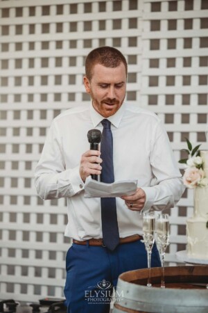 A groomsman makes his wedding speech during the reception