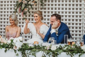 Newlyweds react to the funny wedding speech during their reception