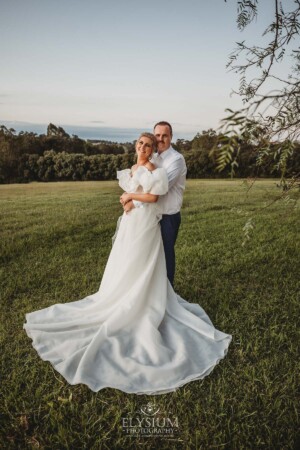 A groom holds his bride in his arms as the celebrate their wedding day