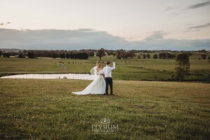 Newlyweds walk hand in hand along the ridge overlooking Burnham Grove at Camden