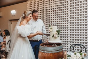 A bride and groom cut their wedding cake during the reception at Burnham Grove