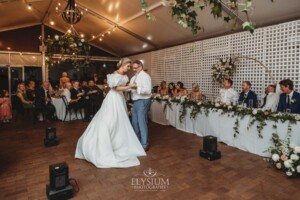 A bride shares a first dance with her father during the wedding reception