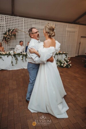 A bride shares a first dance with her father during the wedding reception at Burnham Grove