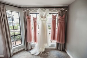 Bridal gowns hand in a large window before the wedding