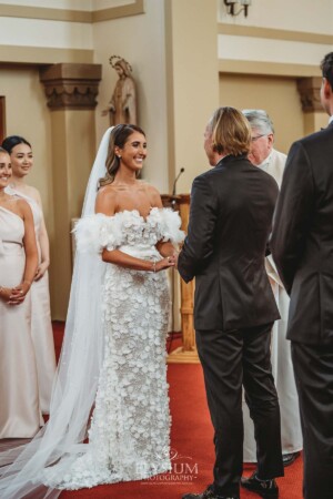 A bride and groom stand in the chapel of Loreto Normanhurst during their wedding ceremony