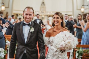A bride and groom walk back down the aisle at Loreto Normanhurst after their wedding ceremony