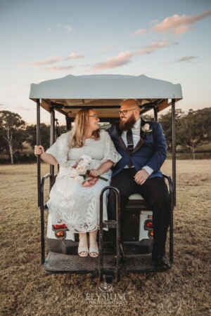 Newlyweds ride down the hill at Ottimo House in a buggy after photos