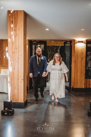 A bride and groom enter their wedding reception at Ottimo House