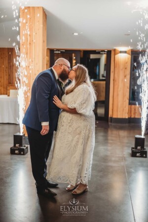 A bride and groom enter their wedding reception at Ottimo House