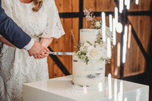 A bride and groom cutting their wedding cake during the reception