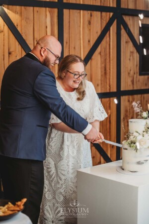 A bride and groom cutting their wedding cake during the reception