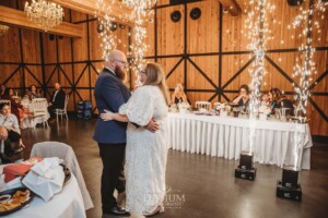 A bride and groom share their first dance surrounded by sparklers