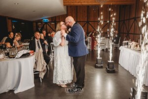 A bride and groom share their first dance surrounded by sparklers