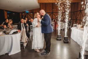 A bride and groom share their first dance surrounded by sparklers