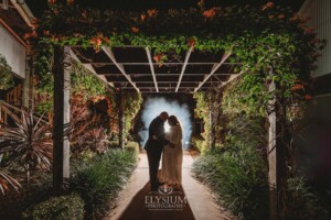 Night photos of a bride and groom under the green pergola at Ottimo House