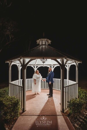 Night photos of a bride and groom under the gazebo at Ottimo House