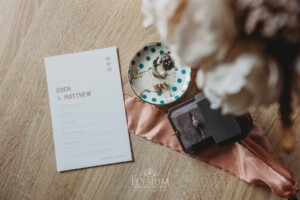 Bridal details laid out on a wooden table in preparation for the wedding