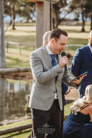 David lang celebrant makes an announcement to wedding guests before the ceremony