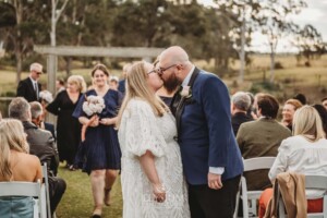 A bride and groom kiss after their wedding ceremony at Ottimo House in Denham Court