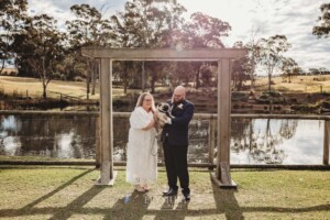 A couple stand with their pug dog after their Ottimo House wedding