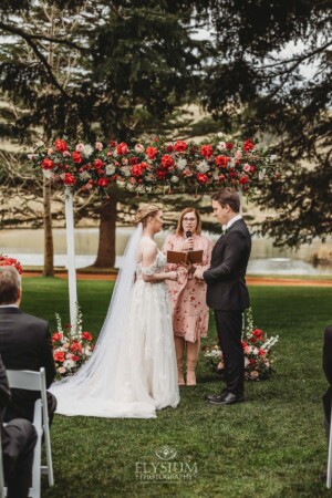 A couple share their wedding vows during the outdoor ceremony on the lawn at Bendooley Estate