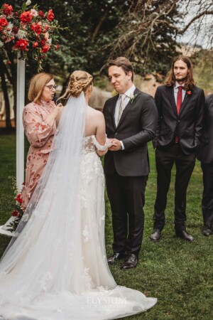 A couple share their wedding vows during the outdoor ceremony on the lawn at Bendooley Estate