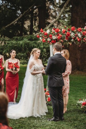 A couple share their wedding vows during the outdoor ceremony on the lawn at Bendooley Estate