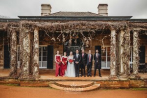 The bridal party pose for photos on the steps of the Bendooley Estate homestead after a wedding