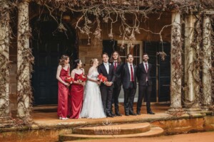 The bridal party pose for photos on the steps of the Bendooley Estate homestead after a wedding