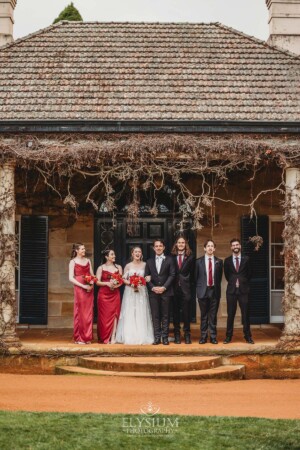 The bridal party pose for photos on the steps of the Bendooley Estate homestead after a wedding