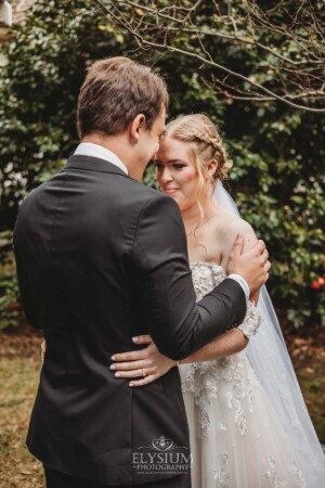 A groom smiles as he sees his bride for the first time during their private first look