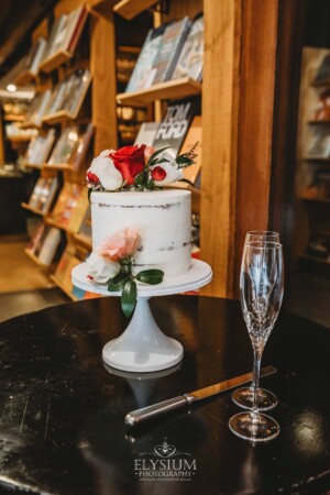 Wedding details showing the cake adorned with flowers