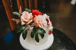 Wedding details showing the cake adorned with flowers