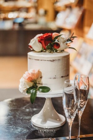Wedding details showing the cake adorned with flowers