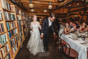 A bride and groom enter their wedding reception at the Bendooley Estate Book Barn