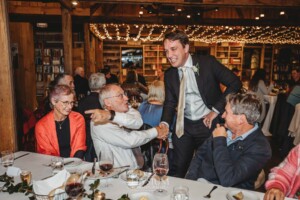 Candid photos of a bride and groom as they mingle with wedding guests during their evening reception