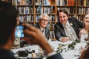 Candid photos of a bride and groom as they mingle with wedding guests during their evening reception