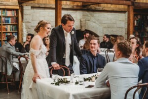 Candid photos of a bride and groom as they mingle with wedding guests during their evening reception