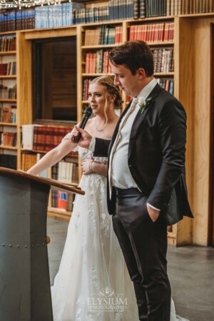A bride and groom share their wedding speech during the reception