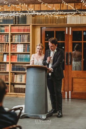 A bride and groom share their wedding speech during the reception