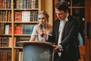 A bride and groom share their wedding speech during the reception