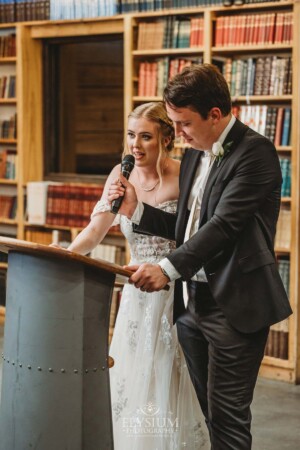 A bride and groom share their wedding speech during the reception