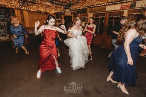 Wedding guests dancing during the reception at Bendooley Estate Book Barn
