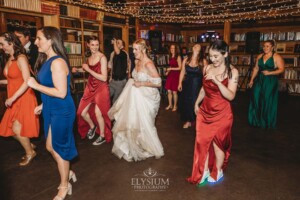 Wedding guests dancing during the reception at Bendooley Estate Book Barn
