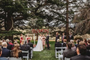 A couple share their wedding vows during the outdoor ceremony on the lawn at Bendooley Estate