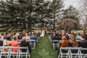 A couple share their wedding vows during the outdoor ceremony on the lawn at Bendooley Estate