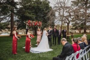 A couple share their wedding vows during the outdoor ceremony on the lawn at Bendooley Estate