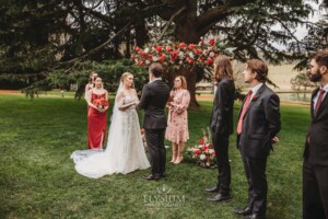 A couple share their wedding vows during the outdoor ceremony on the lawn at Bendooley Estate